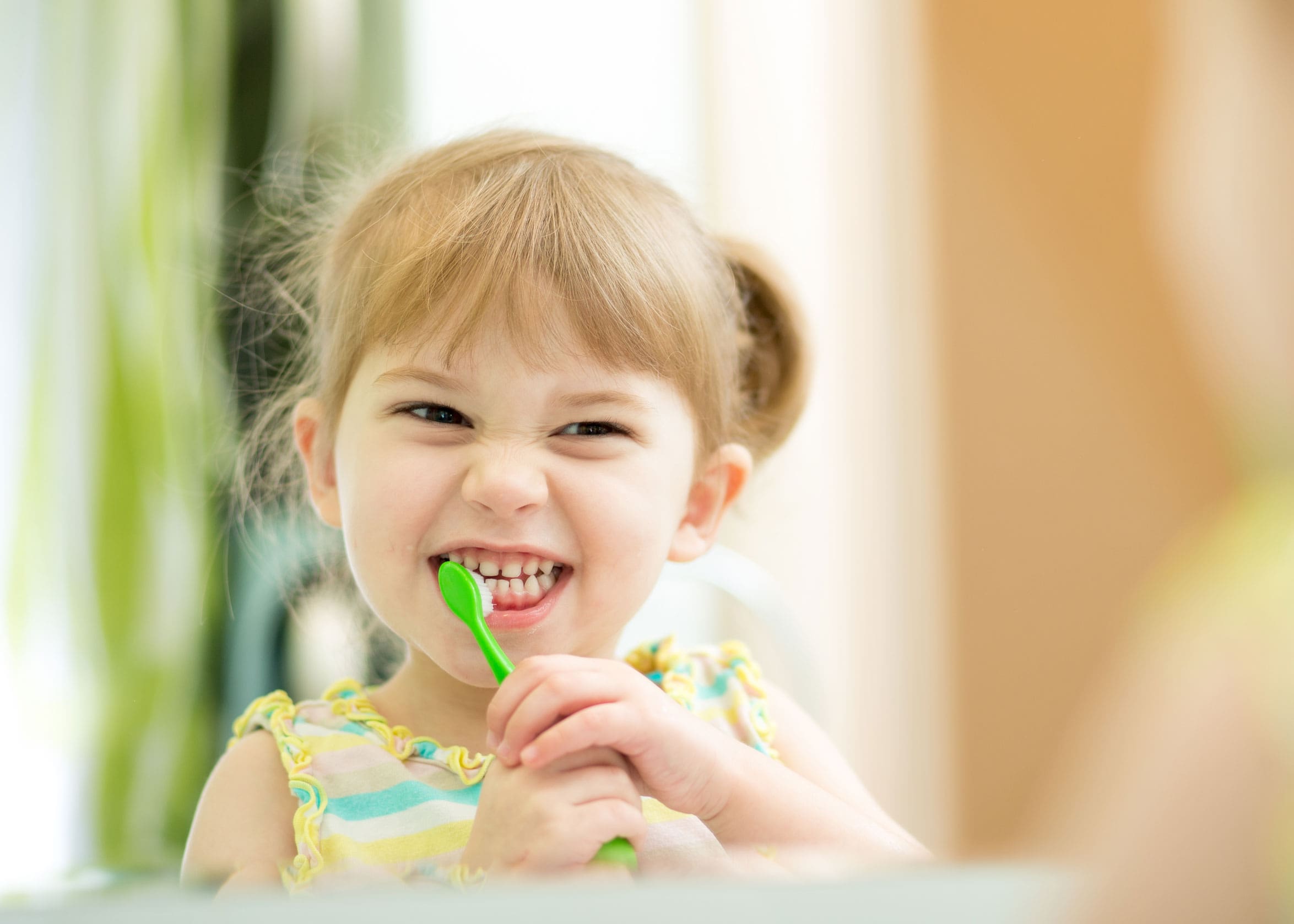 toddler girl brusing teeth